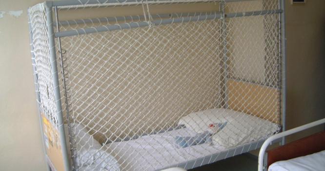 A netted cage bed. © MDAC and the League of Human Rights.